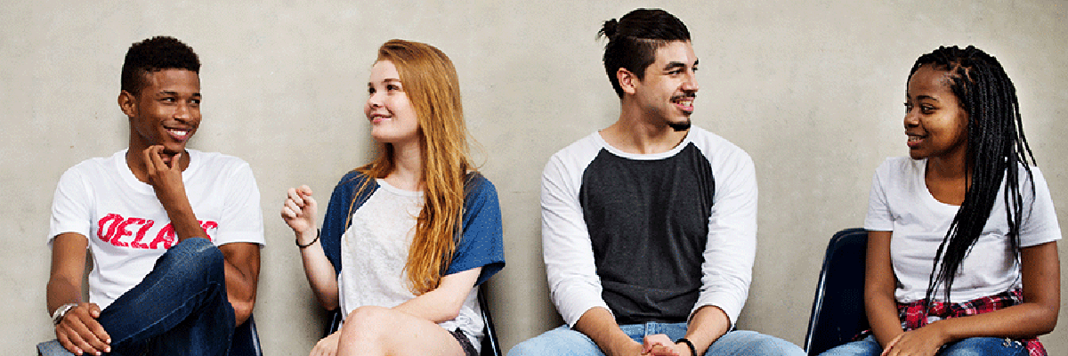 A group of four teens in conversation