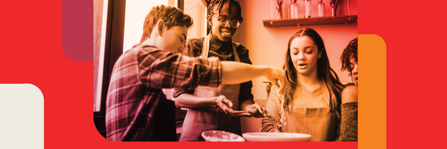 Two teenage boys and two teenage girls enjoying cooking together.