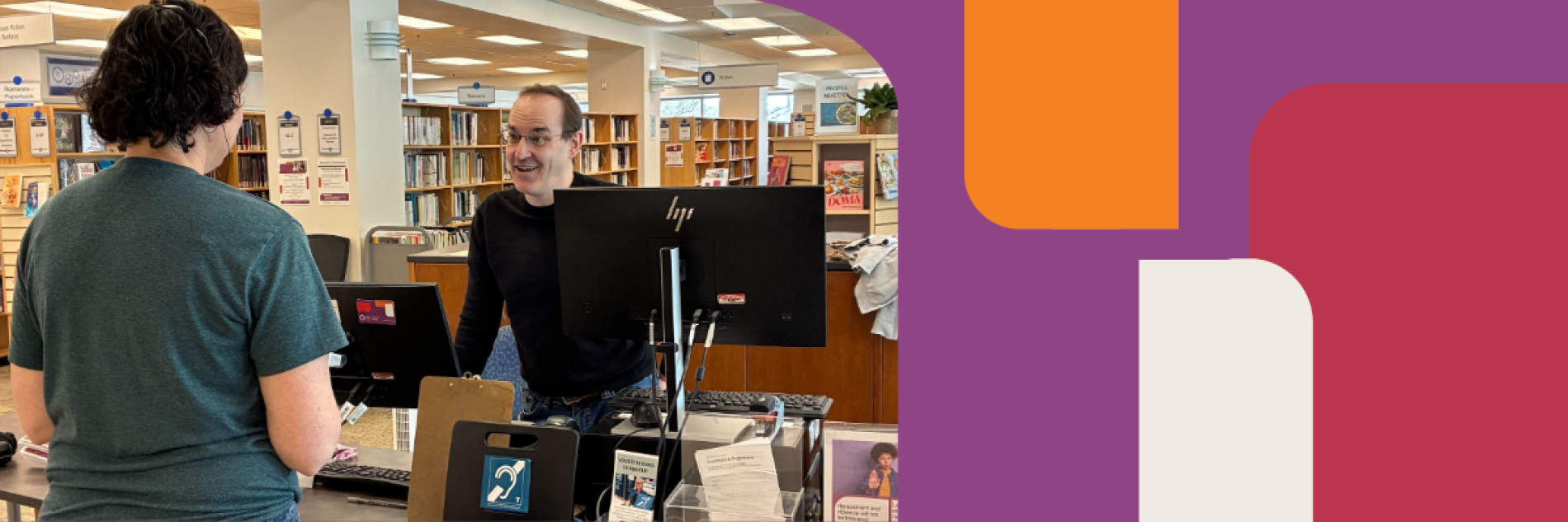 A client wearing a headset and talking to a staff member at the front desk facing the hearing loop device.