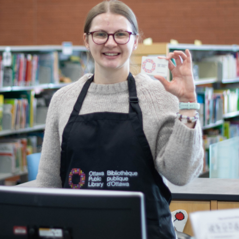 Library staff holding a newly designed library card
