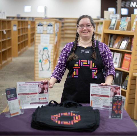 Library staffing handing out new branded bags