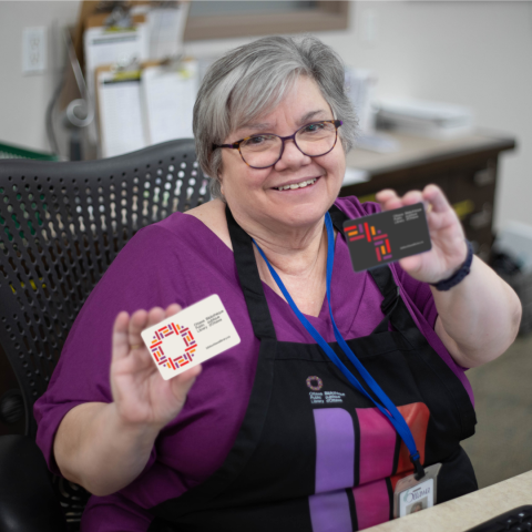 Library staffing holding up a newly designed library card