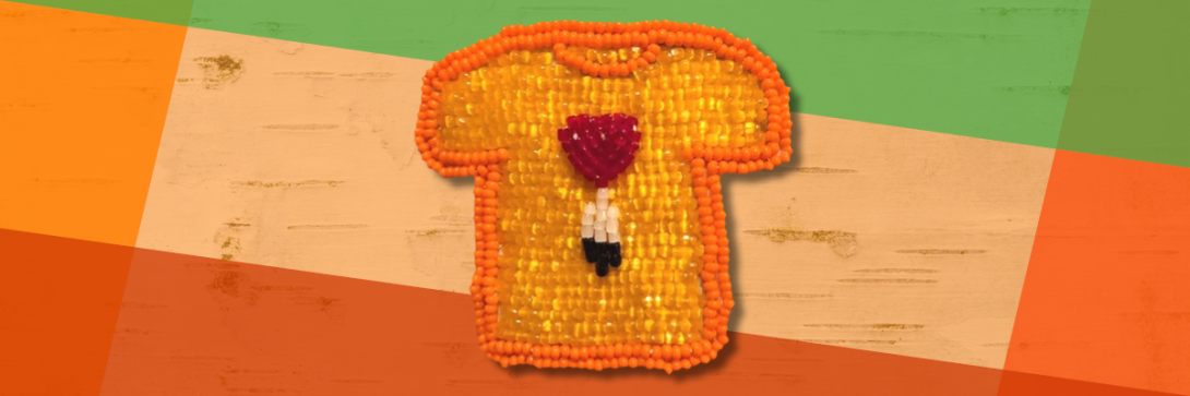 beaded orange t-shirt on orange and green background